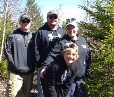 Family from Gorham has just found a geocache.April 2016